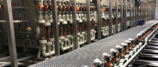 Industrial bottling plant with conveyor belt and filling machinery.